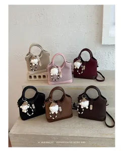 Minimalist retro women handbag with cute plush charm, stylish shoulder crossbody bag for daily.