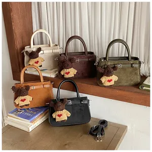 Multi-color fashion commute handbags detail display with cute bear pendants and straps.