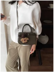 Stylish green commuter handbag with cute bear pendant, chic shoulder crossbody bag for women.