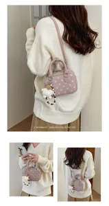 Pink polka dot bowling shoulder bag for women, cute retro crossbody handbag with pendant.