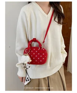 Korean style red polka dot bowling shoulder bag with plush charm and crossbody strap for women.