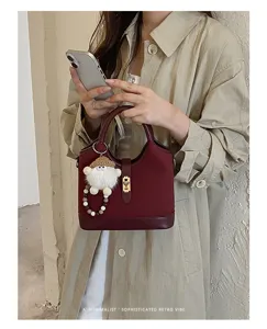 Burgundy leather handbag with metal lock and cute keychain for women retro style daily wear