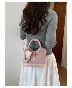 Pink stylish shoulder crossbody bag detail view, casual commute tote bag with metal lock clasp.