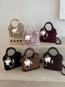 Trendy Korean style women handbag and commuter crossbody shoulder bag with cute fluffy charm.