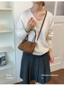 Detailed view of the brown suede bucket shoulder bag, showing stylish daily wear.
