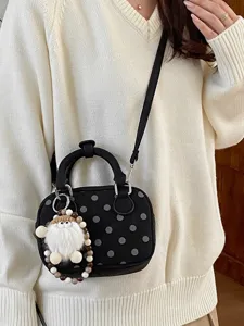 Korean black polka dot bowling shoulder crossbody bag with cute plush doll charm main view.
