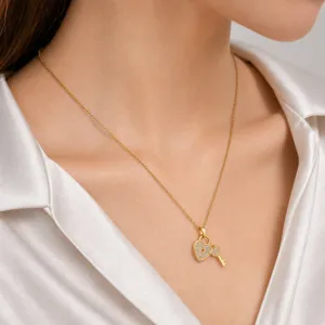 Gold heart lock and key pendant necklace for women, elegant daily fashion jewelry item.