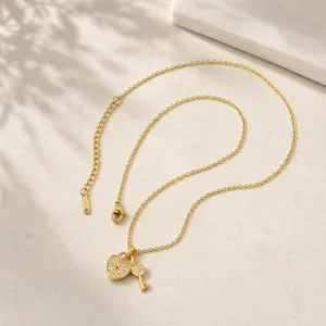 Gold stainless steel heart lock key necklace detail, elegant pavé pendant jewelry piece.