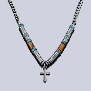Gros plan détaillé du collier tendance avec pendentif croix en métal et perles œil de tigre.