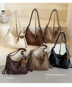 Detailed view of the stylish large capacity shoulder tote bag in multiple colors with cute heart charm.