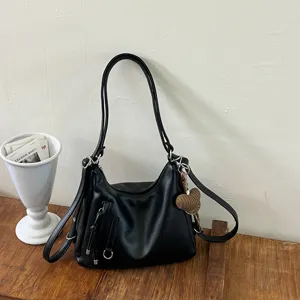 Black leather hobo shoulder bag casual commute handbag with metal hardware and cute heart pendant.