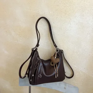 Brown leather hobo shoulder bag with heart pendant, casual commute large capacity tote design.