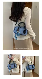Casual denim Boston handbag with black handles and cute star pearl charm for daily use.
