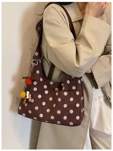 Brown polka dot shoulder bag for women, stylish hobo purse with cute charm and spacious design.