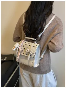Korean retro college style polka dot backpack detail view, cute bow design and charming pendant.