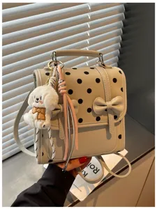 Korean vintage polka dot backpack shoulder bag detail view with cute puppy pendant.