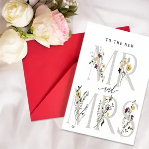 Wedding greeting card detail view with floral typography and red envelope on white background.