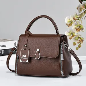 Brown textured leather structured handbag with top handle and crossbody strap for daily use.