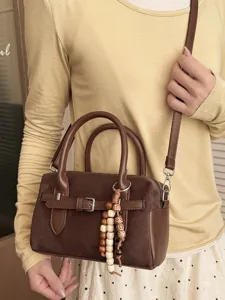 Brown crossbody handbag for women, stylish leather pillow bag and commute shoulder bag.