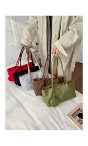 Detail view of the casual minimalist nylon shoulder tote bag showcasing multiple colors and pouch.