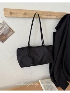 Minimalist black shoulder tote bag with small pouch for women daily casual commute use.