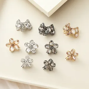 Close-up of sparkling rhinestone flower and bow hair clips, elegant side clip details.