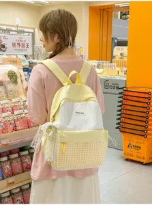 Cute yellow and white plaid schoolbag detail showcasing sweet design and lace pendant.