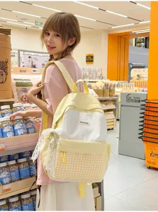 Cute Japanese plaid backpack for students, large capacity casual bookbag with polka dots.