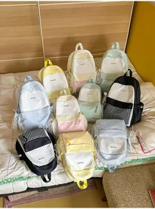 Japanese style cute large capacity student backpack with polka dot and plaid design details.