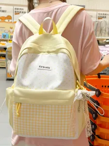 Cute Japanese style yellow student backpack with polka dot and plaid design, large capacity.