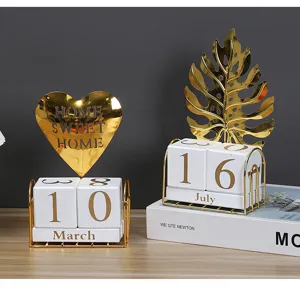 Gold metal and wood block calendar desktop ornament, luxury home decor with heart and leaf design.