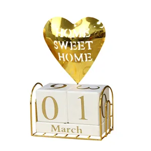 Elegant perpetual desk calendar featuring white wooden blocks and a gold heart topper.