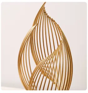 Gold metal abstract sculpture detail, modern decorative ornament for living room desk decor.