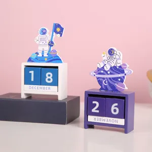 Wooden perpetual desk calendar with cute astronaut space cartoon design for home and office decor.