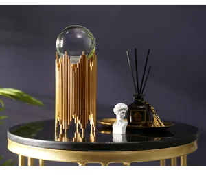 Luxury crystal ball ornament detail, featuring clear glass sphere and gold metal stand.