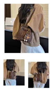 Detail view of retro leopard print bucket bag with flower charm, stylish shoulder crossbody bag.