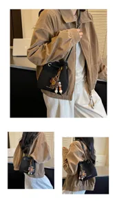 Trendy women retro suede bucket bag with floral charm, casual daily shoulder handbag.