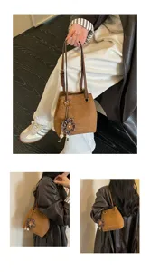 Retro suede bucket bag for women, stylish shoulder crossbody handbag with flower pendant.