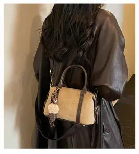 Retro suede Boston bag detail, dark brown leather trim, chic charm, elegant commuter style.