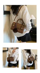 Detail view of retro woven shoulder bag with chic pompom charm, elegant daily wear style.