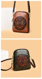 Close-up detail of retro embossed floral leather cross-body cell phone bag in brown and green.