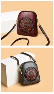 Detailed view of the vintage embossed shoulder phone bag with dual zippers and floral design.