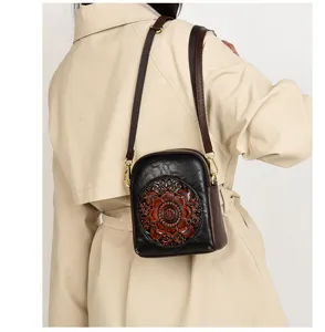 Detailed back view of retro embossed black crossbody phone bag worn by model, chic.