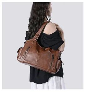 Detailed view of the brown leather shoulder bag with multiple pockets and durable straps.