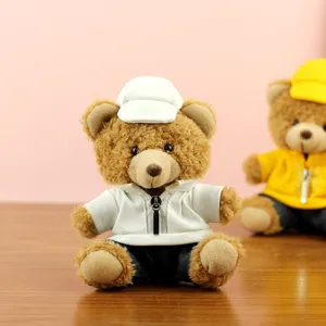 Cute teddy bear plush toy detailed view, soft stuffed animal dressed in stylish white hoodie outfit.