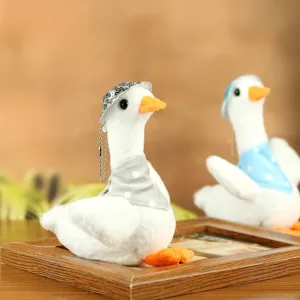 Detailed view of cute plush duck toy, soft stuffed animal with sequin hat and cute mini scarf.