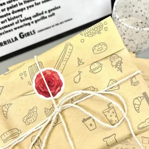 Detailed close-up view of floral decorative sticker on vintage craft paper package.