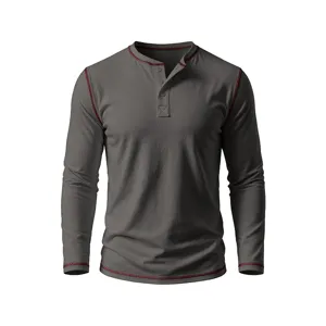 Detailed view of the dark grey mens long sleeve henley t-shirt with red contrast stitching.
