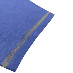 Blue cotton t-shirt fabric detail view, showing neat stitching and soft textile texture.