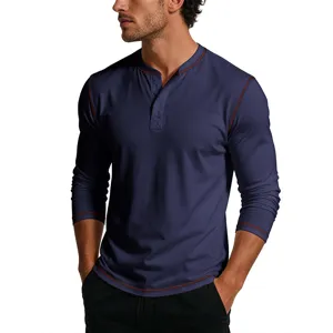 Close-up detail of men's long sleeve Henley shirt with contrast red stitching and buttons.